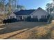 Single-story home featuring a well-manicured lawn and mature landscaping at 135 Lucky Leaf Pl, Fayetteville, GA 30214
