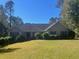 Charming single-story home featuring a well-manicured lawn and mature trees at 135 Lucky Leaf Pl, Fayetteville, GA 30214