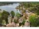 An aerial view of homes on a lush landscaped property by a lake at 3711 Spinnaker Cir, Alpharetta, GA 30005