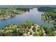 A scenic aerial view of neighborhood homes nestled on a lush, treelined lake at 3711 Spinnaker Cir, Alpharetta, GA 30005