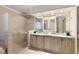 Bright bathroom featuring double vanity and a textured glass shower with glass doors at 3711 Spinnaker Cir, Alpharetta, GA 30005