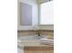 A close-up of a soaking tub featuring a window and a piece of artwork at 3711 Spinnaker Cir, Alpharetta, GA 30005