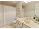 A bright bathroom featuring a cream sink, shower, toilet, and a mirror at 3711 Spinnaker Cir, Alpharetta, GA 30005