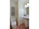 Powder room with pedestal sink, wainscoting and unique tile flooring at 3711 Spinnaker Cir, Alpharetta, GA 30005