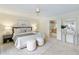 Bright main bedroom with white accents, art, bedside lamps, and ensuite bathroom at 3711 Spinnaker Cir, Alpharetta, GA 30005