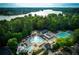 Aerial view of a community pool and clubhouse surrounded by mature trees at 3711 Spinnaker Cir, Alpharetta, GA 30005