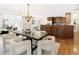 Open concept dining room features stylish chandelier and views to the kitchen at 3711 Spinnaker Cir, Alpharetta, GA 30005