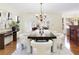 Elegant dining room features a chandelier, modern decor, and abundant natural light at 3711 Spinnaker Cir, Alpharetta, GA 30005