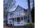 Two-story home with large windows, white trim, a covered porch, and a second-story balcony at 3711 Spinnaker Cir, Alpharetta, GA 30005