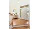 Bright foyer with hardwood floors, a staircase, and stylish decor creating an inviting entryway at 3711 Spinnaker Cir, Alpharetta, GA 30005