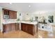 Modern kitchen boasts wooden cabinets, island, and is connected to a dining area at 3711 Spinnaker Cir, Alpharetta, GA 30005