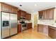 Updated kitchen with stainless steel appliances, wooden cabinets, and ample counter space at 3711 Spinnaker Cir, Alpharetta, GA 30005