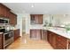 Updated kitchen with stainless steel appliances, wooden cabinets, and modern fixtures at 3711 Spinnaker Cir, Alpharetta, GA 30005