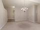 A brightly lit, carpeted living room with stairs and a chandelier at 3711 Spinnaker Cir, Alpharetta, GA 30005