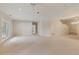 A large carpeted living area featuring French doors and stairs at 3711 Spinnaker Cir, Alpharetta, GA 30005
