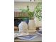 Close-up of stylish vases and decor on a coffee table near a fireplace in a bright living room at 3711 Spinnaker Cir, Alpharetta, GA 30005
