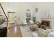 Open living room with a fireplace, high ceilings, and natural light, creating a warm and inviting atmosphere at 3711 Spinnaker Cir, Alpharetta, GA 30005