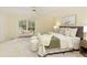 Bright primary bedroom with ensuite bathroom and sitting bench and view of the lake at 3711 Spinnaker Cir, Alpharetta, GA 30005
