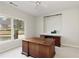 Office space featuring a large desk, shelving, and a scenic window view at 3711 Spinnaker Cir, Alpharetta, GA 30005