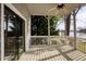 Covered porch featuring a ceiling fan, overlooking the beautiful lake at 3711 Spinnaker Cir, Alpharetta, GA 30005
