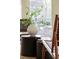 Close up on sunroom plants and decor with views of the lake and landscaping at 3711 Spinnaker Cir, Alpharetta, GA 30005
