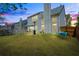 Backyard with patio dining set and swing against a colorful sunset at 512 Watercress Dr, Woodstock, GA 30188