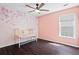 Charming bedroom with floral wallpaper, fan and wood floor at 512 Watercress Dr, Woodstock, GA 30188