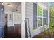 Inviting entryway showcasing hardwood floors, decorative pillars, and a glimpse into the formal dining room at 512 Watercress Dr, Woodstock, GA 30188
