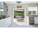 Bright kitchen featuring white cabinets, stainless steel appliances, and a view of the outdoor patio at 512 Watercress Dr, Woodstock, GA 30188
