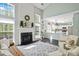 Bright living room features vaulted ceilings, a fireplace, large windows, and an open plan to the kitchen at 512 Watercress Dr, Woodstock, GA 30188
