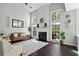 Bright living room features vaulted ceilings, a fireplace, large windows, and stylish decor at 512 Watercress Dr, Woodstock, GA 30188
