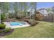 Expansive backyard with a sparkling pool, diving board, playground, and wooden swing set at 625 Park Creek Trce, Alpharetta, GA 30005