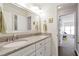 Elegant bathroom showcasing a double vanity with granite countertop and a doorway leading to a bedroom at 625 Park Creek Trce, Alpharetta, GA 30005