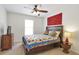 Cozy bedroom with a queen-sized bed, colorful quilt, and a decorative side table with a lamp at 625 Park Creek Trce, Alpharetta, GA 30005