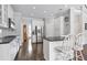 Modern kitchen with stainless steel appliances, an island with barstool seating, and hardwood floors at 625 Park Creek Trce, Alpharetta, GA 30005