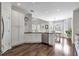 Bright kitchen featuring stainless steel appliances, dark hardwood floors, and white cabinets at 625 Park Creek Trce, Alpharetta, GA 30005