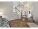 Open living room showcasing hardwood floors, stairs, and a comfortable seating area with an area rug at 625 Park Creek Trce, Alpharetta, GA 30005