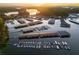Aerial view of a marina filled with boats and docks on a tranquil lake during sunset at 6477 Old Shadburn Ferry Rd, Buford, GA 30518