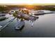 An aerial view of the marina at sunset displays waterfront facilities and covered boat storage at 6477 Old Shadburn Ferry Rd, Buford, GA 30518