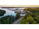 An aerial view shows a lakefront community with covered boat docks and lush wooded surroundings at 6477 Old Shadburn Ferry Rd, Buford, GA 30518