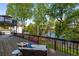 Enjoy lake views from this spacious deck with comfortable seating and lush greenery at 6477 Old Shadburn Ferry Rd, Buford, GA 30518