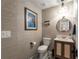 Half bath featuring wallpaper walls, geometric tile floors, a modern mirror, an updated vanity, and stylish lighting at 6477 Old Shadburn Ferry Rd, Buford, GA 30518