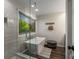 This modern bathroom boasts a sleek glass shower and luxurious soaking tub with a picturesque window view at 6477 Old Shadburn Ferry Rd, Buford, GA 30518