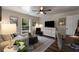Cozy bedroom features a comfortable seating area, soft colors, and ample natural light from the window at 6477 Old Shadburn Ferry Rd, Buford, GA 30518