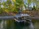Multiple boat slips with lifts attached, the roof has chairs and room for activities at 6477 Old Shadburn Ferry Rd, Buford, GA 30518
