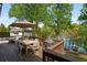 Relaxing deck area with outdoor furniture, grill, and a view of the serene lake, perfect for entertaining at 6477 Old Shadburn Ferry Rd, Buford, GA 30518