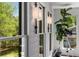 Window seating area with two modern light fixtures, many large windows with outdoor views, and a telescope at 6477 Old Shadburn Ferry Rd, Buford, GA 30518