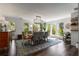 Bright dining room with ship lap walls, modern lighting fixture, large windows with beautiful outdoor views, and an area for entertaining at 6477 Old Shadburn Ferry Rd, Buford, GA 30518