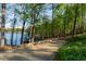 A long driveway that leads to the lake with multiple boat slips in view at 6477 Old Shadburn Ferry Rd, Buford, GA 30518