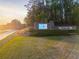 Well-maintained entrance sign to the community featuring lush greenery and a display screen at 6477 Old Shadburn Ferry Rd, Buford, GA 30518